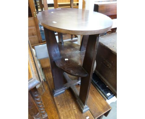 An Arts and Crafts Glasgow School oak table, the oval top above an oval shelf, supported on a cruciform base (height 75.5cm, 