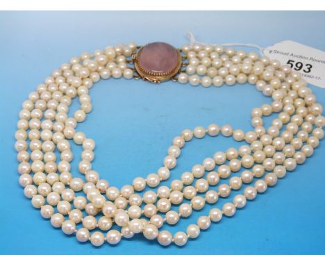 A five strand pearl necklace with a 15ct gold clasp set with a large rose quartz stone