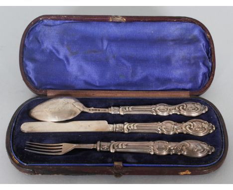 A VICTORIAN CASED THREE PIECE CHRISTENING SET, knife, fork and spoon.