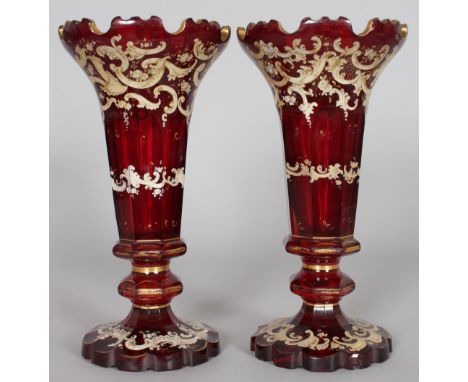 A PAIR OF RUBY GLASS TRUMPET SHAPED VASES, LATE 19TH CENTURY, with gilded and enamel decoration. 11ins high.