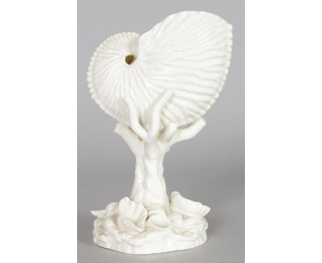 A ROYAL WORCESTER NAUTILUS VASE, white glazed with shell shape bowl on a naturalistic base. 7ins high.