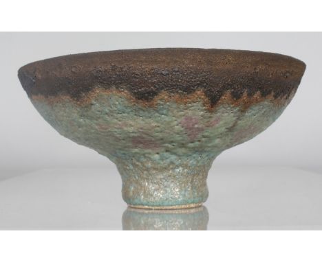 DAME LUCIE RIE (1902-1995) AUSTRIAN A FOOTED CIRCULAR BOWL with volcanic glaze. Impressed Mark.  8.5ins diameter, 4ins high.