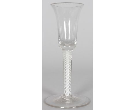 A GEORGIAN WINE GLASS with inverted bell bowl, white opaque twist stem. 6ins high.