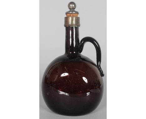 AN AMETHYST GLASS SPIRIT FLAGON with metal stopper. 8.5ins high.