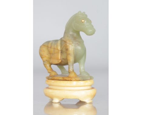 A CHINESE CARVED JADE HORSE on a stand. 3ins high.