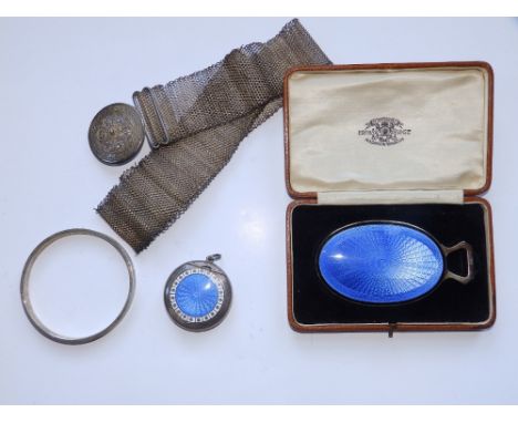 A small blue enamelled hand mirror - Orr &amp; Sons, a compact, a filigree belt and a bangle. (4)