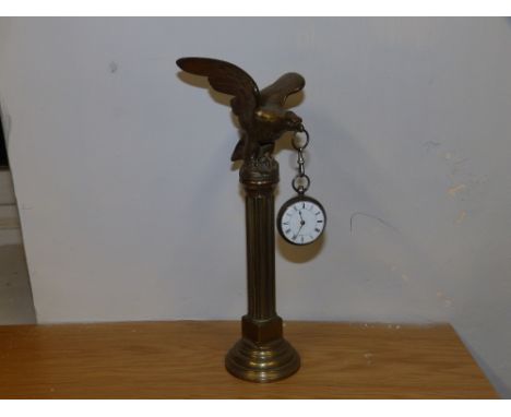 A silver fusee pocket watch on bird of prey stand.