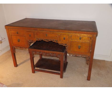 A 19thC Chinese golden lacquered kneehole dressing table and matching stool, the table with an arrangement of seven short dra