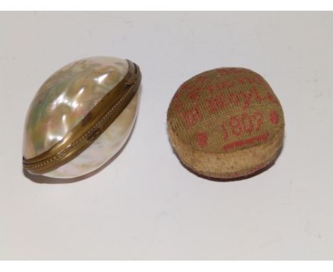 A Regency embroidered spherical fabric pin cushion and a mother-of-pearl shell box. (2)
