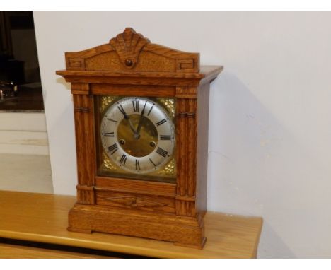 A Victorian oak repeating mantel clock.