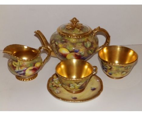 A Royal Worcester fruit painted four piece solo tea serice, the cream jug, sugar bowl and teacup with gilded interiors. (5)