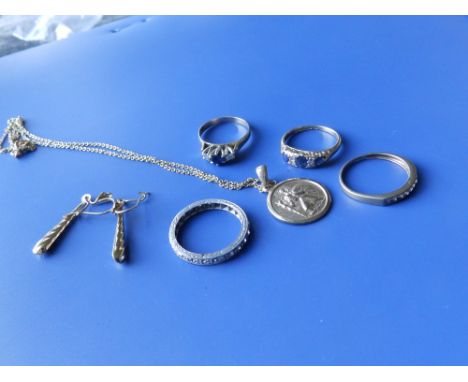 Two sapphire &amp; diamond rings, two diamond set 9ct rings, a pair of earrings and a small medallion on chain. (7)