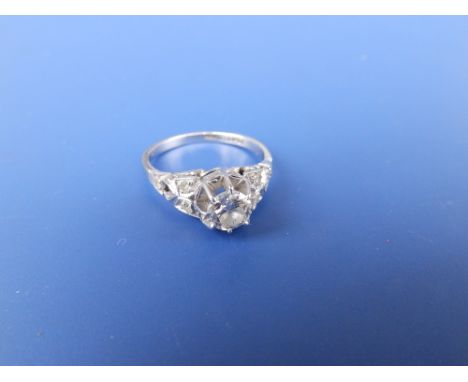 A diamond solitaire, the high claw set brilliant weighing approximately 0.50 carats, small diamonds to shoulders.  Finger siz