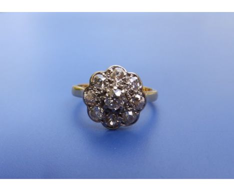 A diamond 'daisy'cluster ring in 18ct yellow metal. Finger size M/N.