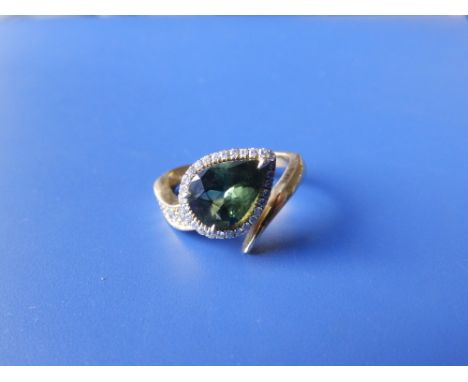 A certified natural green sapphire &amp; diamond ring, the pear shaped stone in cluster setting of open crossover style in ye