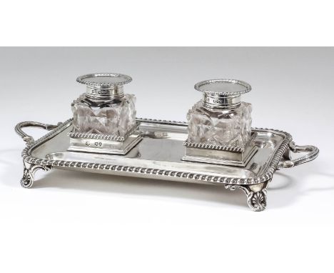 A late Victorian silver rectangular two-handled ink stand with gadroon mounts, reeded handles and on scroll moulded panel fee