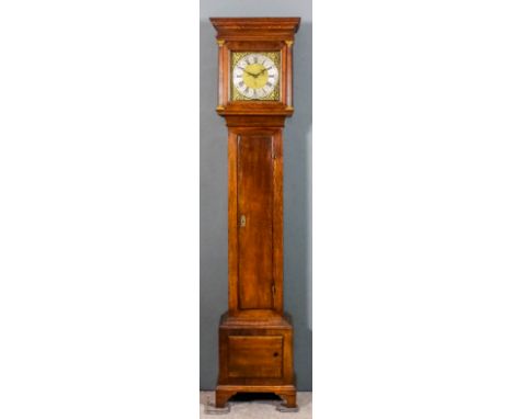 An 18th Century oak longcase clock, the 11ins square brass dial with wide silvered chapter ring with Roman and Arabic numeral