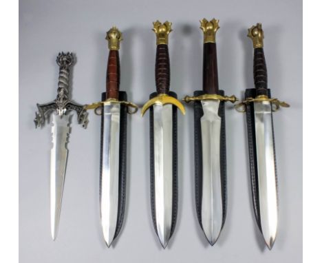 Four modern large fantasy daggers, each with double edged 12ins bright steel blade, brass cross guard and pommel, hardwood hi