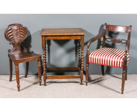 A William IV mahogany hall chair, the shaped back of scroll outline, with reeded crest rail and recessed shield panel, wood s