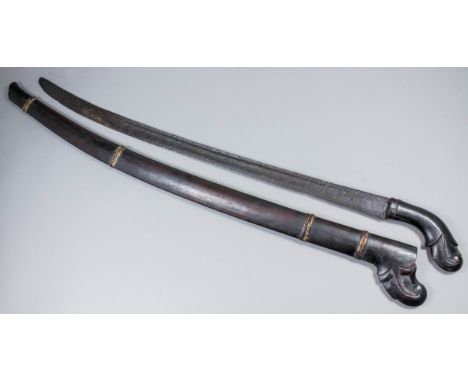 A Far Eastern sabre, 31ins single edged semi curved and fullered blade, carved wood grip and guard with wood scabbard, 42ins 