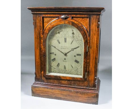 A Victorian walnut cased mantel clock by John Walker, 203 Regent Street, London, the 18ins arched silvered dial with Roman nu