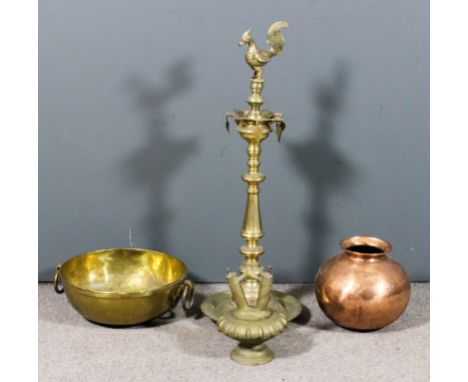 An Indian brass oil lamp with seven spouts and mythical bird pattern terminal, on octagonal turned and bulbous central column