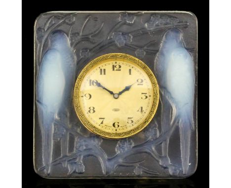 A 1920's René Lalique "Inseparables" opalescent desk clock moulded in relief with two pairs of lovebirds seated on prunus blo