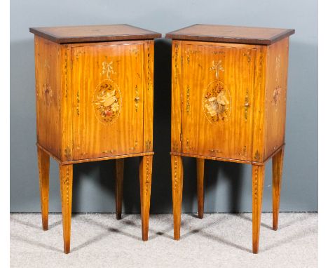 A pair of late 20th Century satinwood bedside cabinets of "Sheraton" design, the whole painted with ribbon swag floral orname