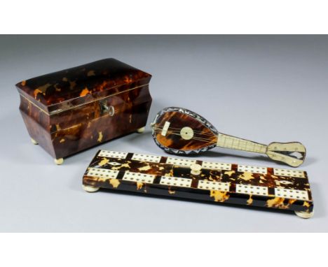 A tortoiseshell rectangular tea caddy with four turned ivory feet, 5.75ins x 3.5ins x 3.75ins high, a tortoiseshell and bone 