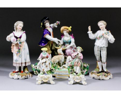 A pair of late 19th Century Continental porcelain figures of a young man and woman, both with flower garlands, each 8.75ins h