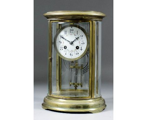 An early 20th Century French brass and bevelled glass cased oval "Four Glass" mantel clock, No. 165752, the 3.5ins diameter w