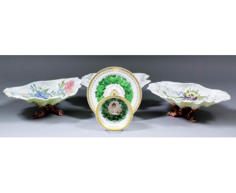 A 19th Century Berlin porcelain cup and saucer, the rims with gilt detail, both with a garland of ivy leaves, the cup with a 
