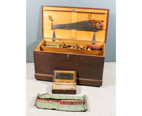 A carpenters stained pine chest, 36ins wide x 18ins deep x 19ins high, containing a selection of carpenters tools,  including