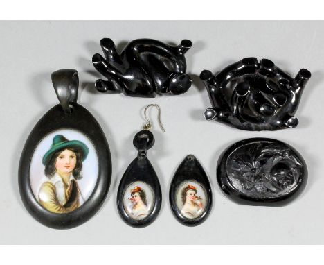 A late Victorian jet oval pattern pendant set to the centre with oval porcelain panel of young man, 70mm x 40mm overall, a pa