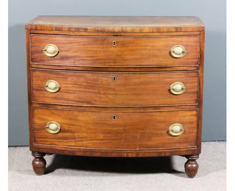 A George III mahogany bow front chest inlaid with ebonised stringings, with square edge to top, fitted three long drawers, on