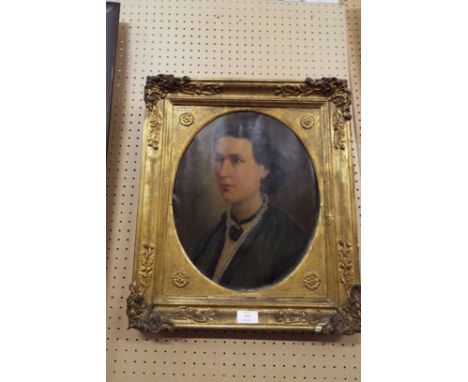 A 19thC oil on canvas portrait of a lady in mourning jewellery, unsigned and housed in an ornate gilt frame