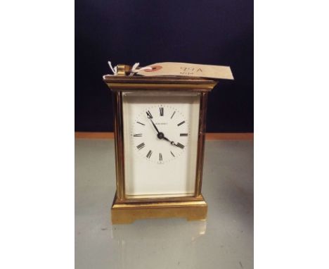A Jean Renet brass carriage clock with bevelled glass