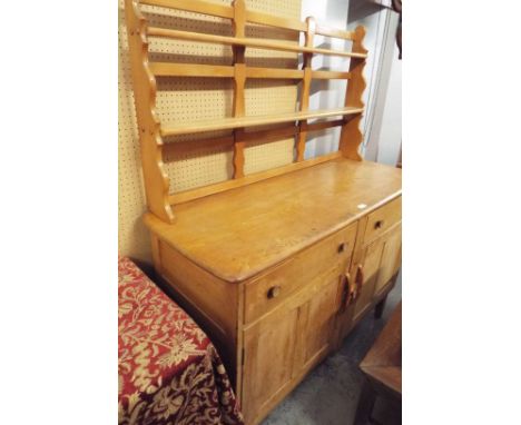 A mid-20thC Ercol elm dresser, the two shelf rack over two short drawers and two panelled cupboards