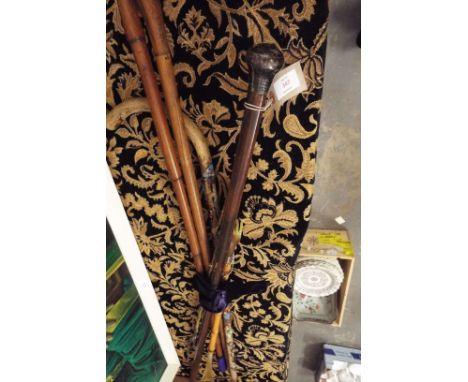 An Edwardian walnut walking cane with silver knop handle dated London 1904, together with an early 20thC walking stick in the