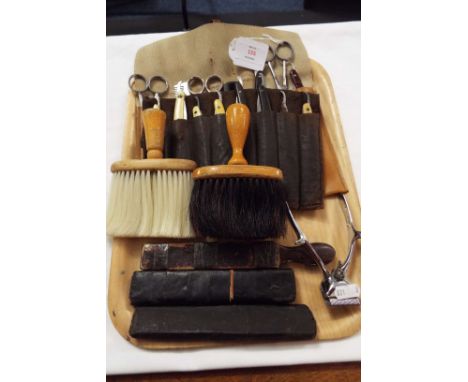 A collection of vintage barber's tools to include cut throat razors, neck brushes, scissors, combs, clippers etc  One razor h