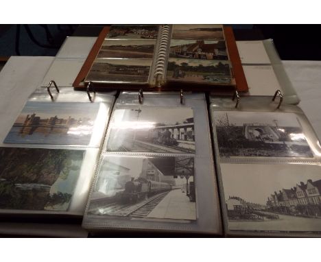 Four albums of vintage postcards to include trains, seaside, village and scenic examples  1st album approx 96 Hastings, 2nd 8