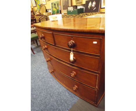 A Victorian mahogany bow front chest of two short over three long graduated cock beaded drawers with turned handles