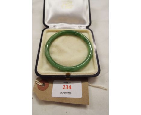 A 20thC Jade bangle with case  Internal diameter 6 cm, external 7.5 cm