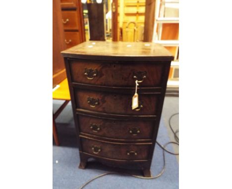 An early 20thC Georgian style mahogany cross banded bow front chest of four cock beaded drawers each with ornate brass swan n