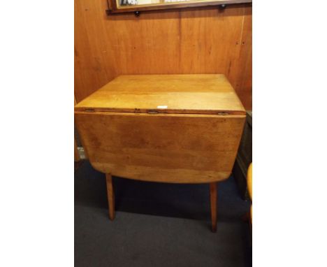 An Ercol drop leaf dining table together with two carvers and single chair