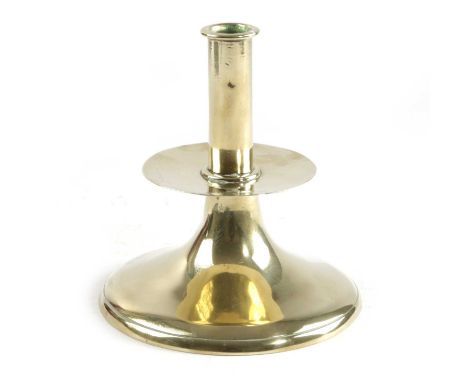 A CHARLES II BRASS TRUMPET CANDLESTICKC.1660 AND LATERthe plain stem above a central drip-tray and a spreading foot15.5cm hig