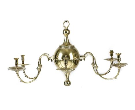 A GEORGE II BRASS SIX-LIGHT CHANDELIERC.1730the turned nozzles above a broad drip-pan on scrolling arms issuing from a centra