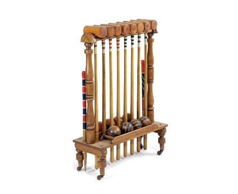 A CROQUET SET ON STANDBY AYRES, LATE 19TH / EARLY 20TH CENTURYcomprising: eight mallets stamped 'FW AYRES LONDON', eight ball