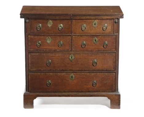 A SMALL GEORGE II OAK BACHELOR'S CHESTC.1735-40the hinged fold-over top above four short and two long crossbanded drawers, on