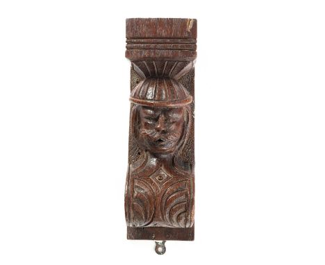 AN OAK CORBEL 17TH CENTURYcarved with the head of a man sporting a moustache30cm high